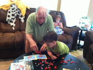 Declan and Pop working on a Lego boat